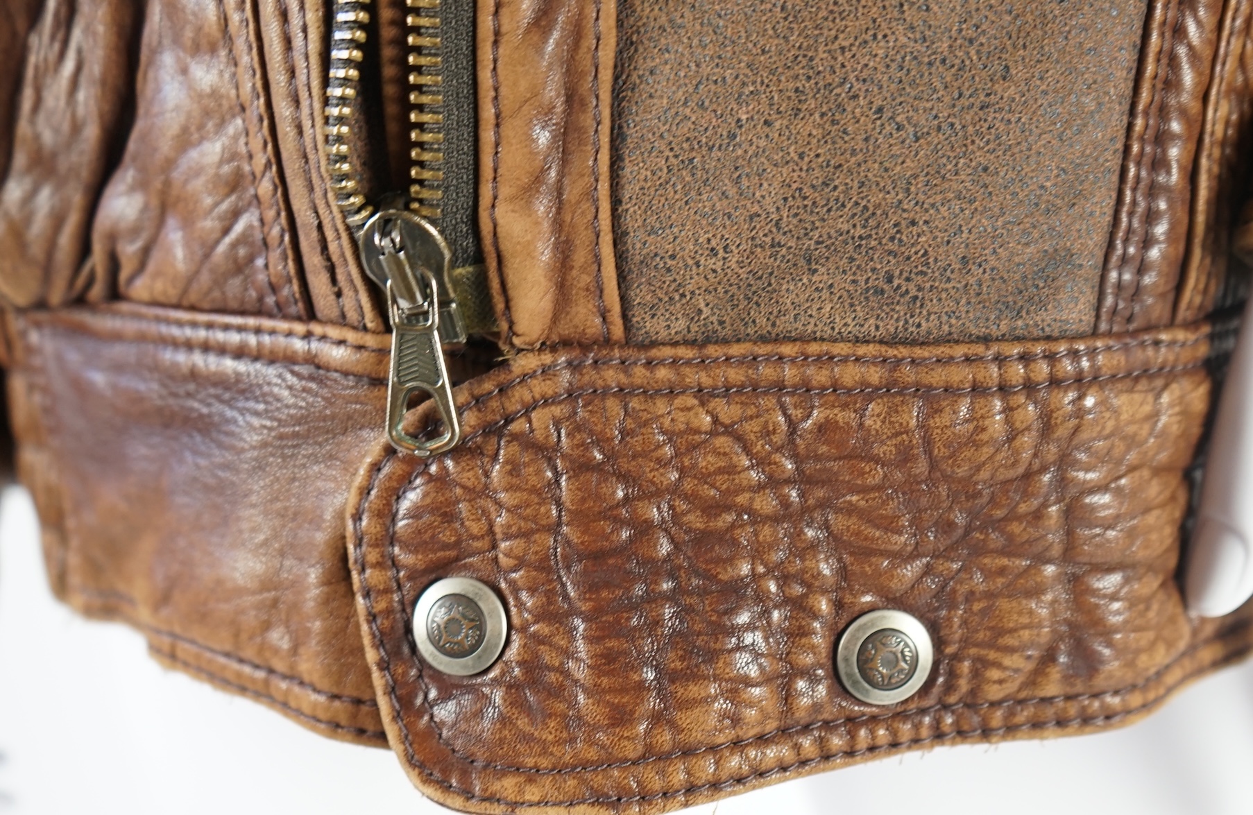 A gentleman's vintage brown leather bomber jacket made by The King, size unknown.